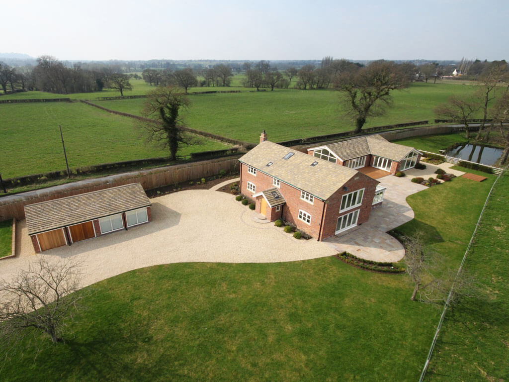 3 buildings set in fields photographed from the air